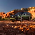 Green 2027 Subaru Outback parked on red rock terrain
